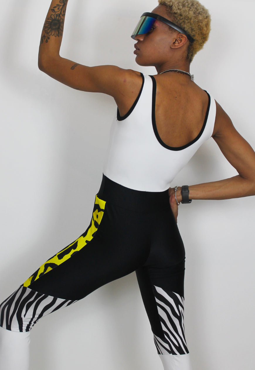 Dimepiece - Black and white jumpsuit with zebra and yellow leopard panel.