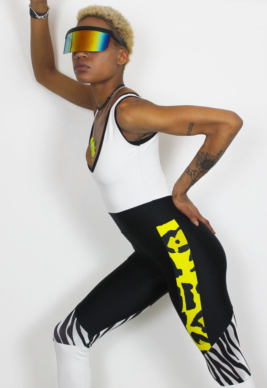 Dimepiece - Black and white jumpsuit with zebra and yellow leopard panel.