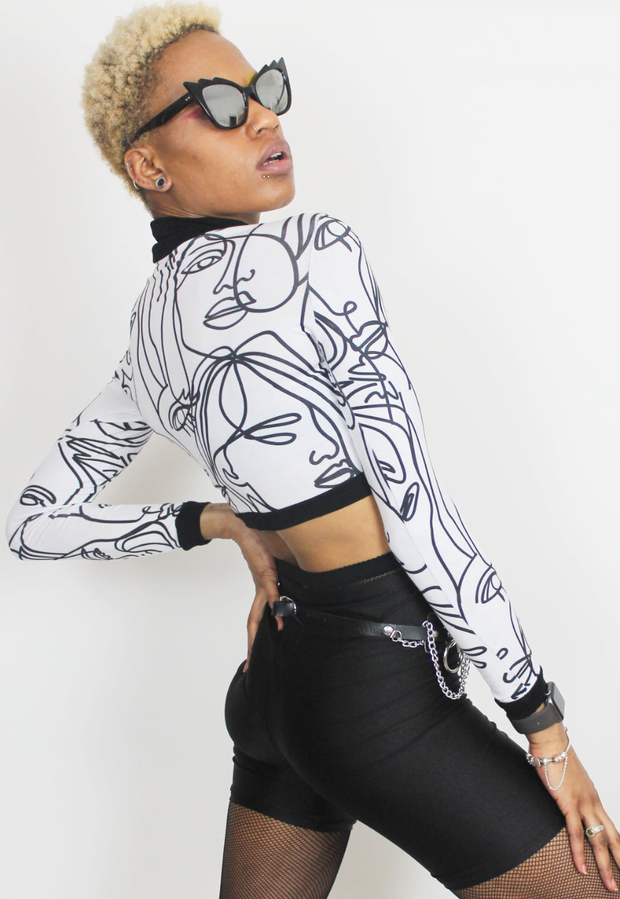 Face Off - Long sleeved white crop top with abstract face print