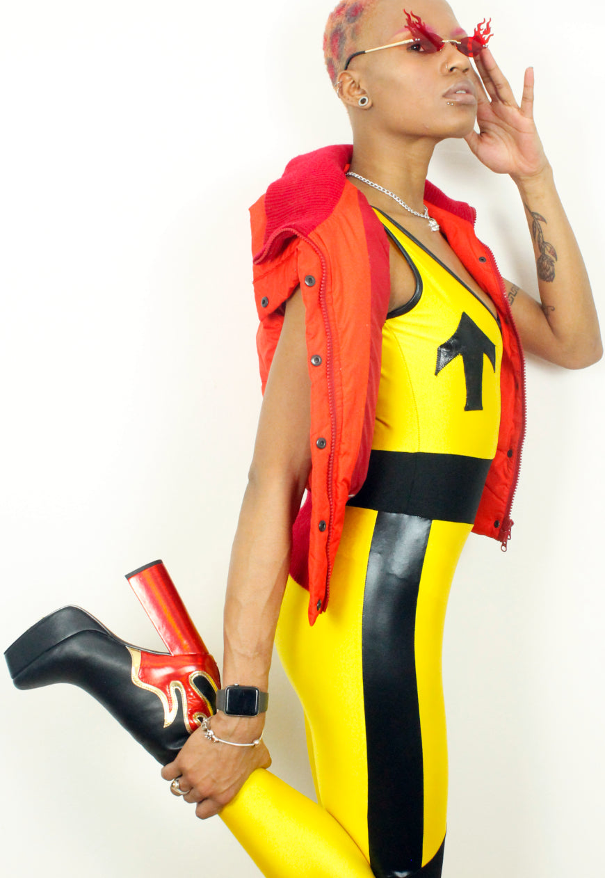Havoc - yellow spandex jumpsuit with black panels and arrow appliqués
