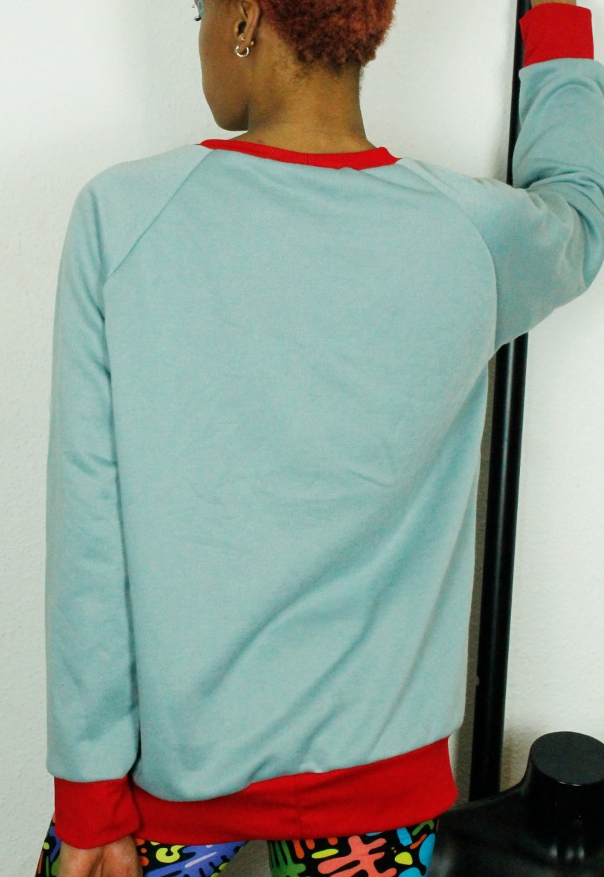 LOVE HURTS Baby blue oversize sweater with large heart and lightning bolts