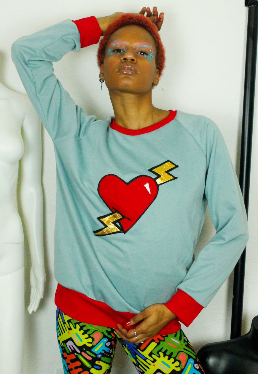 LOVE HURTS Baby blue oversize sweater with large heart and lightning bolts