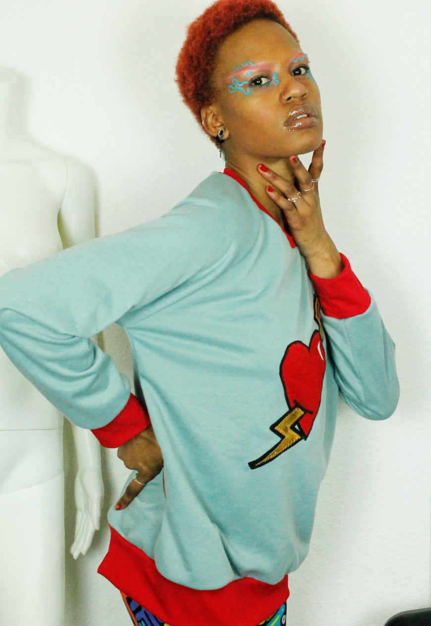LOVE HURTS Baby blue oversize sweater with large heart and lightning bolts