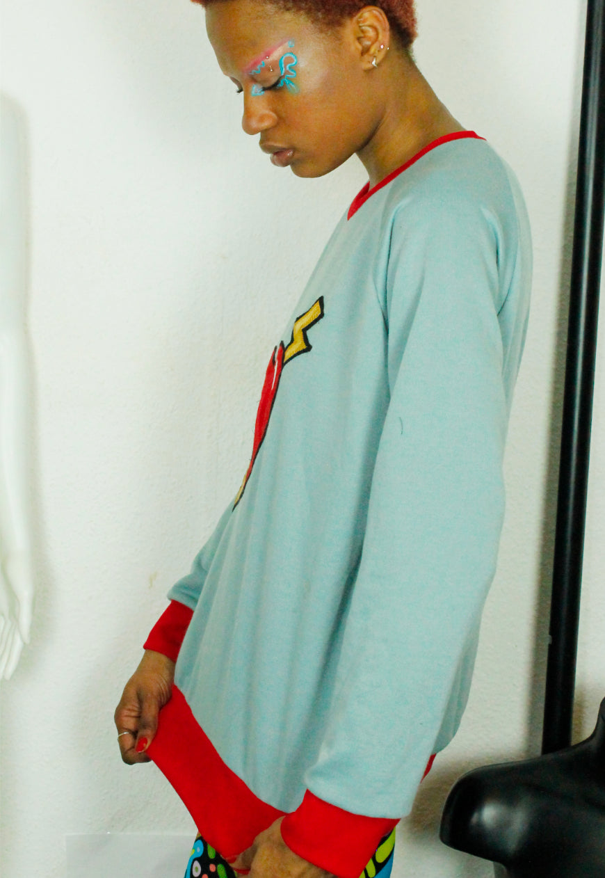 LOVE HURTS Baby blue oversize sweater with large heart and lightning bolts