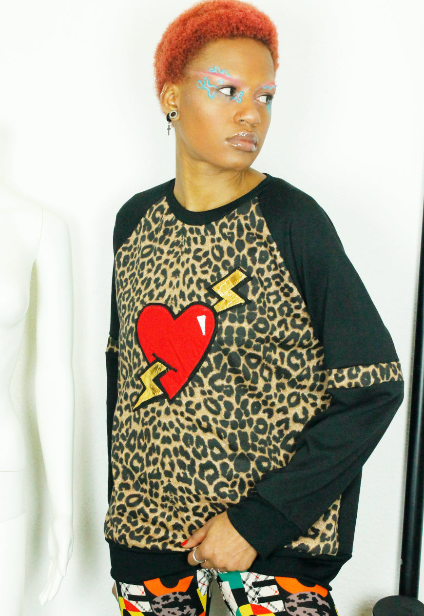 LOVE HURTS Leopard and black oversize sweater with large heart and lightning bolts