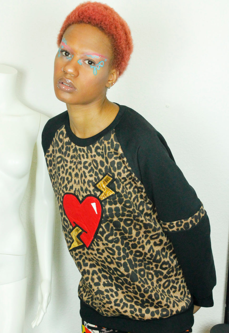 LOVE HURTS Leopard and black oversize sweater with large heart and lightning bolts