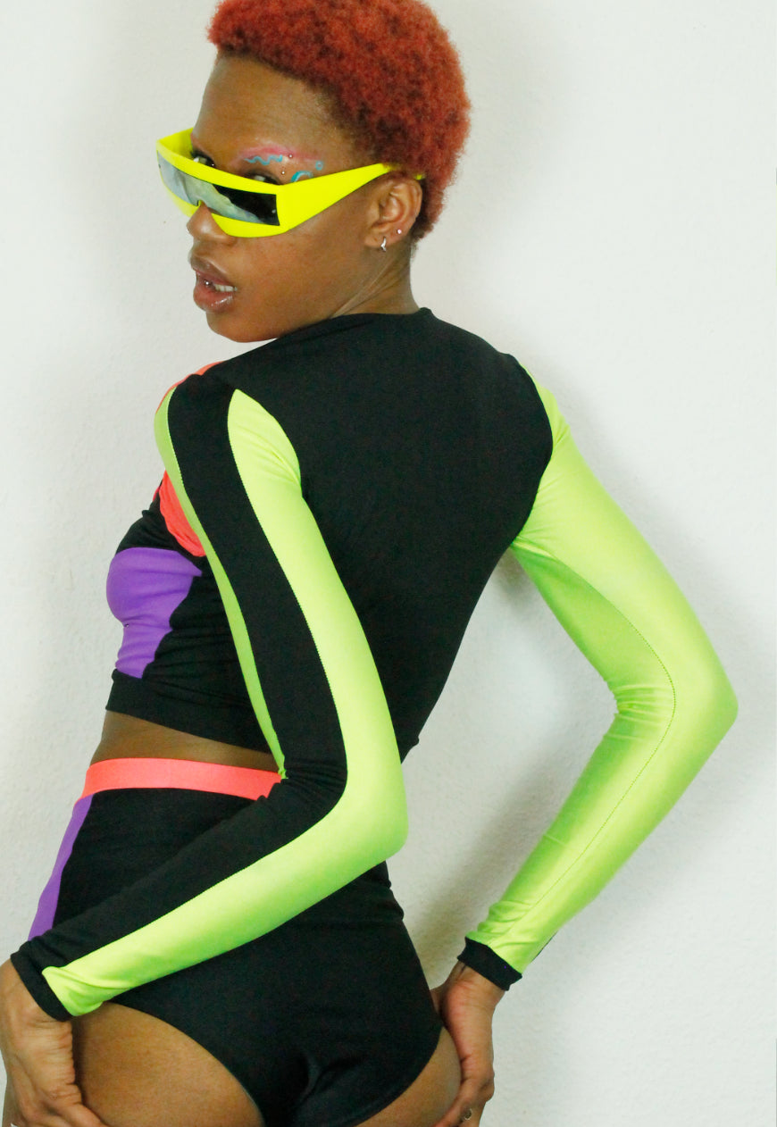QUIVER Purple, neon and black panel peekaboo top.