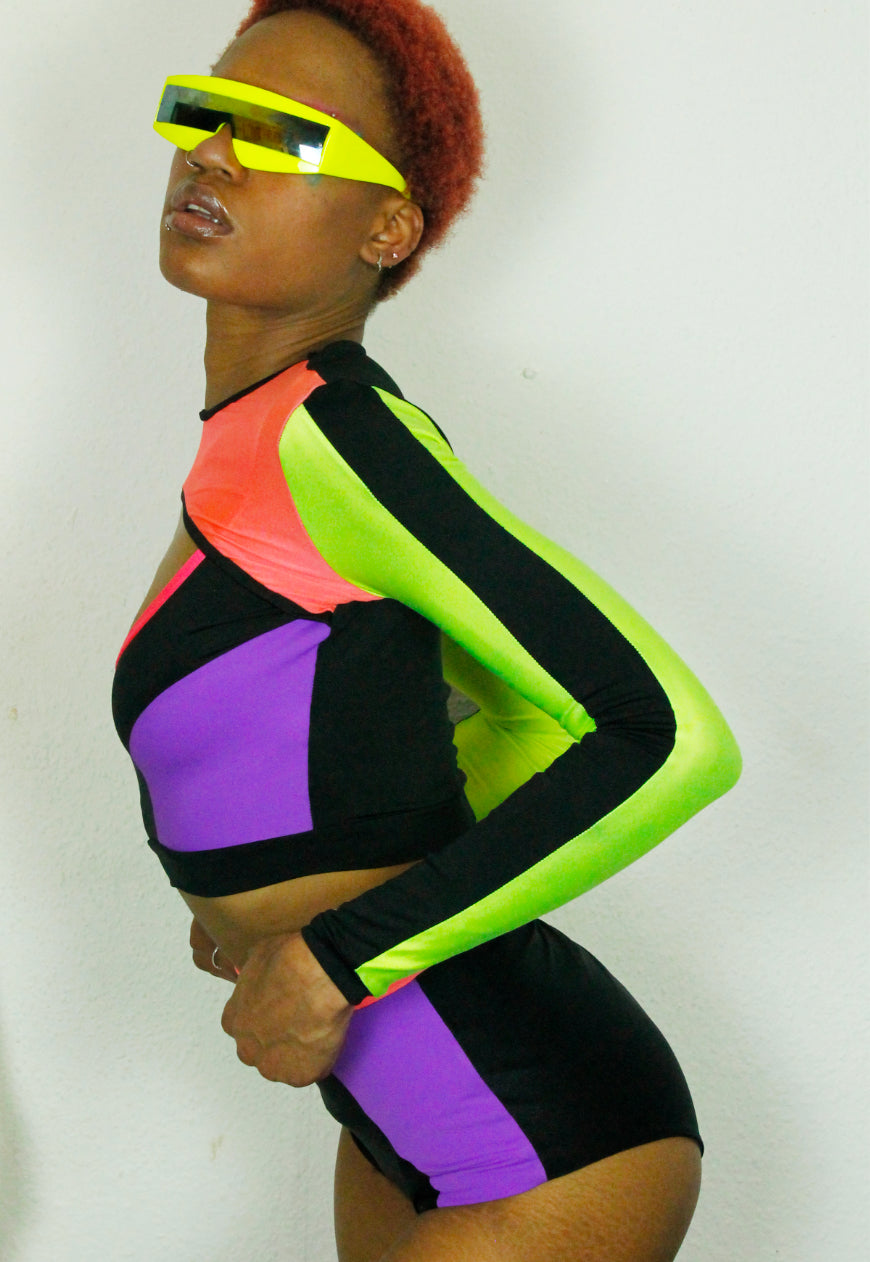 QUIVER Purple, neon and black panel peekaboo top.