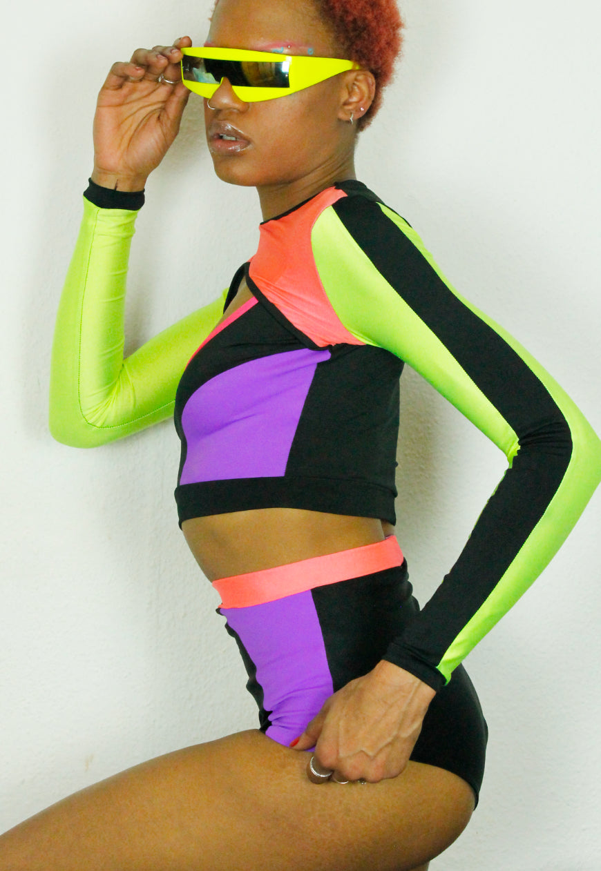 QUIVER Purple, neon and black panel peekaboo top.