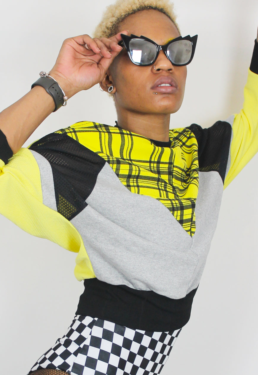 Cher  - Yellow tartan batwing jumper with black and grey colour block panels.