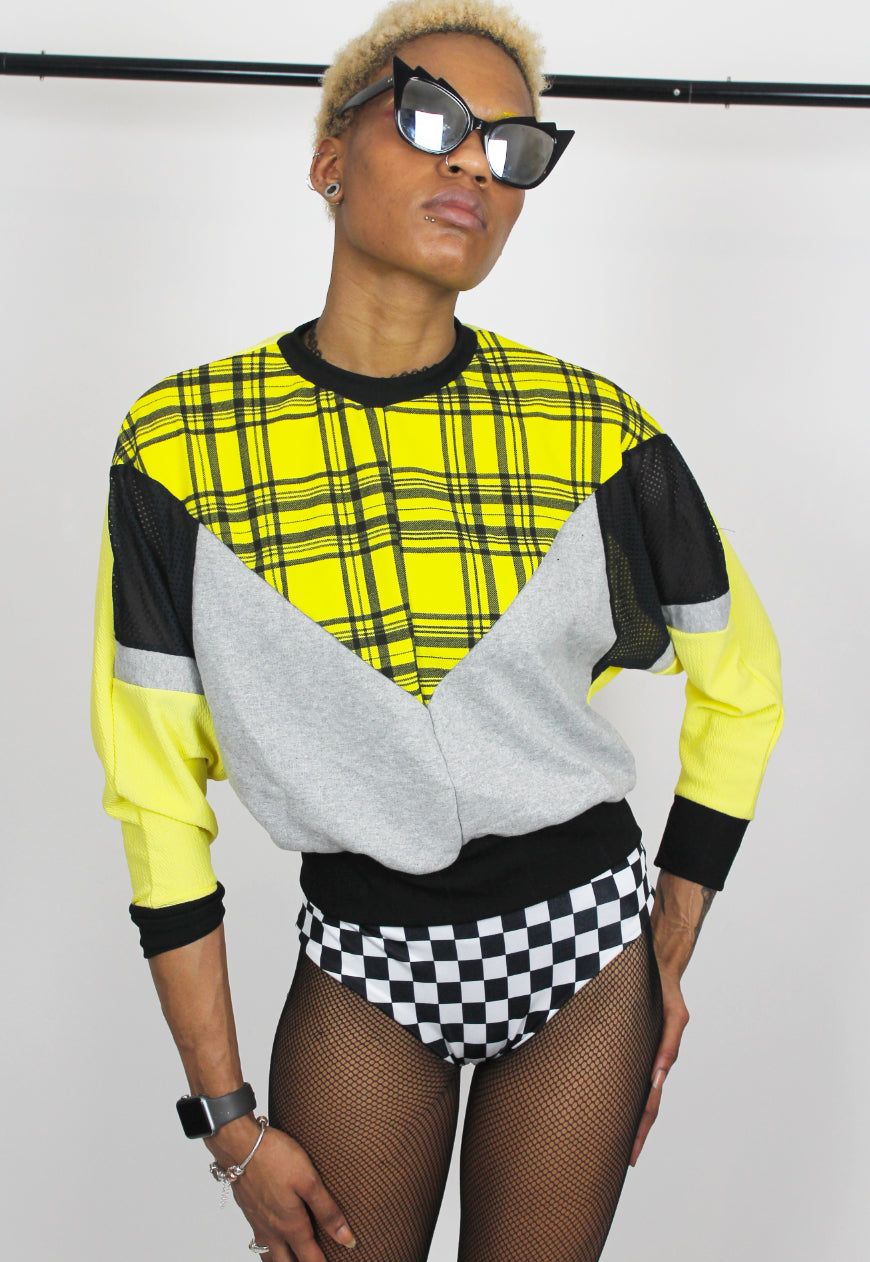 Cher  - Yellow tartan batwing jumper with black and grey colour block panels.