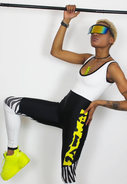 Dimepiece - Black and white jumpsuit with zebra and yellow leopard panel.