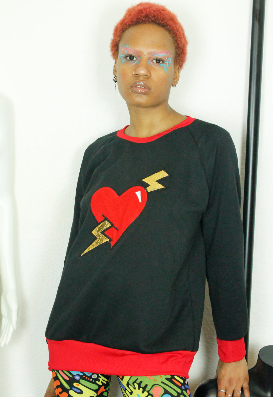 LOVE HURTS Black oversize sweater with large heart and lightning bolts